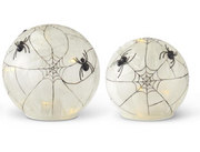 Two spherical Halloween decorations with spider webs and spiders on a white background