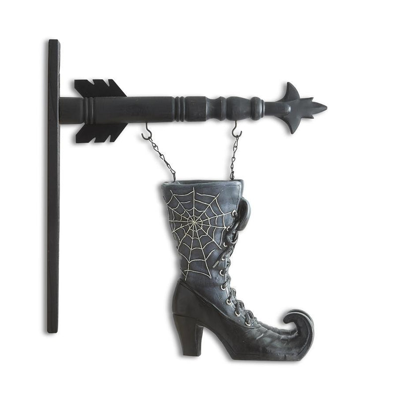 Decorative wall hook shaped like a witch's boot with spider web design and an arrow on a white background.