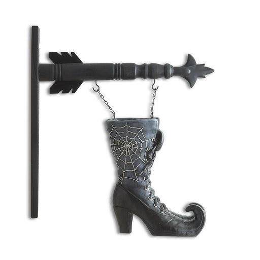 Decorative wall hook shaped like a witch's boot with spider web design and an arrow on a white background.