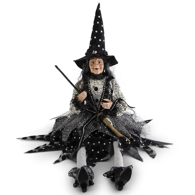 Halloween witch doll with black hat and dress on a white background