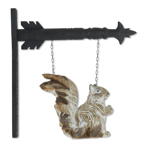 Decorative squirrel hanging from a black arrow on a white background