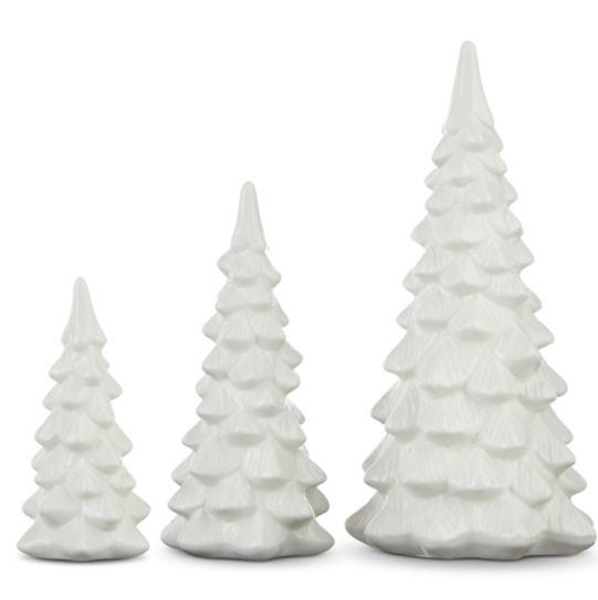 Three white ceramic Christmas tree figurines of varying sizes on a white background