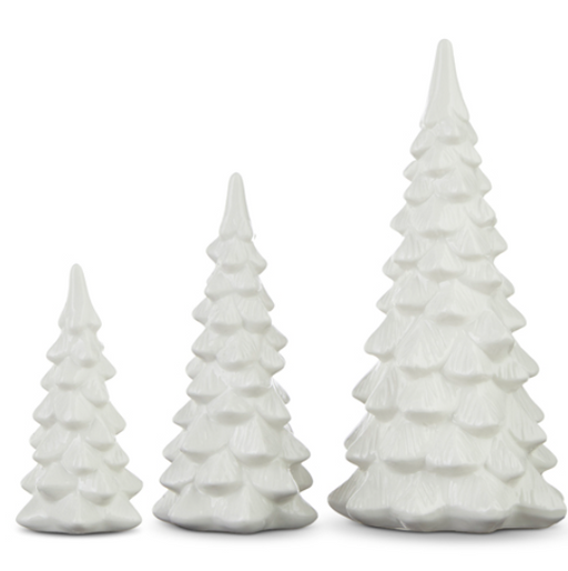 Three white ceramic Christmas tree figurines of varying sizes on a white background