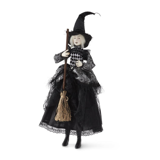 Halloween witch doll with a broom on a white background