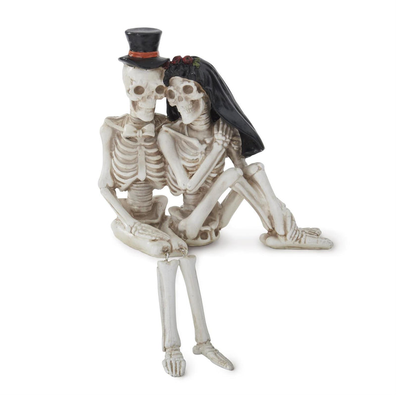Skeletal couple figurine with top hat and veil on a white background