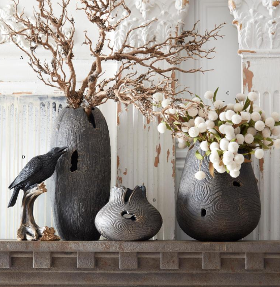 Decorative vases with natural elements on a mantelpiece