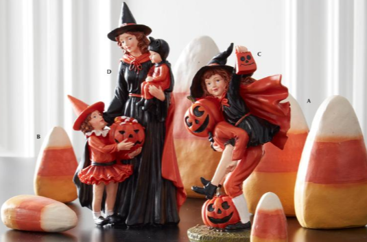 Halloween-themed figurines with children in costumes and candy corn decorations.