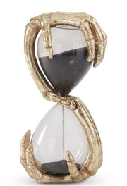 Decorative hourglass with gold metallic casing on a white background