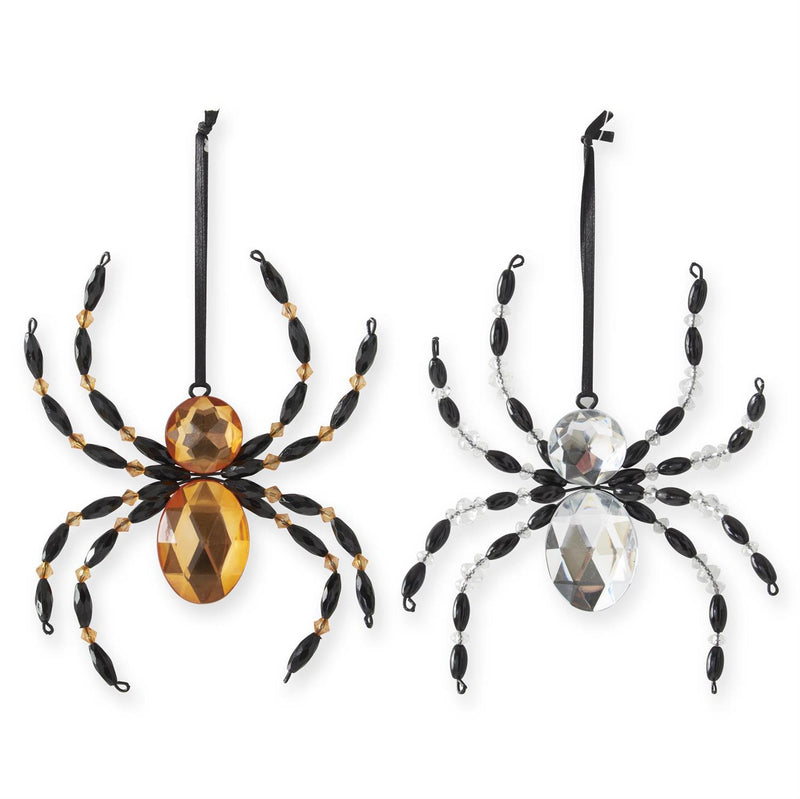 Two decorative spider ornaments with beaded legs on a white background