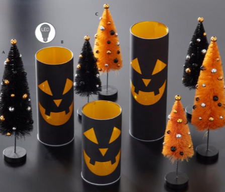 Halloween-themed decorations including black and orange cylindrical trees with jack-o'-lantern faces on a dark background.