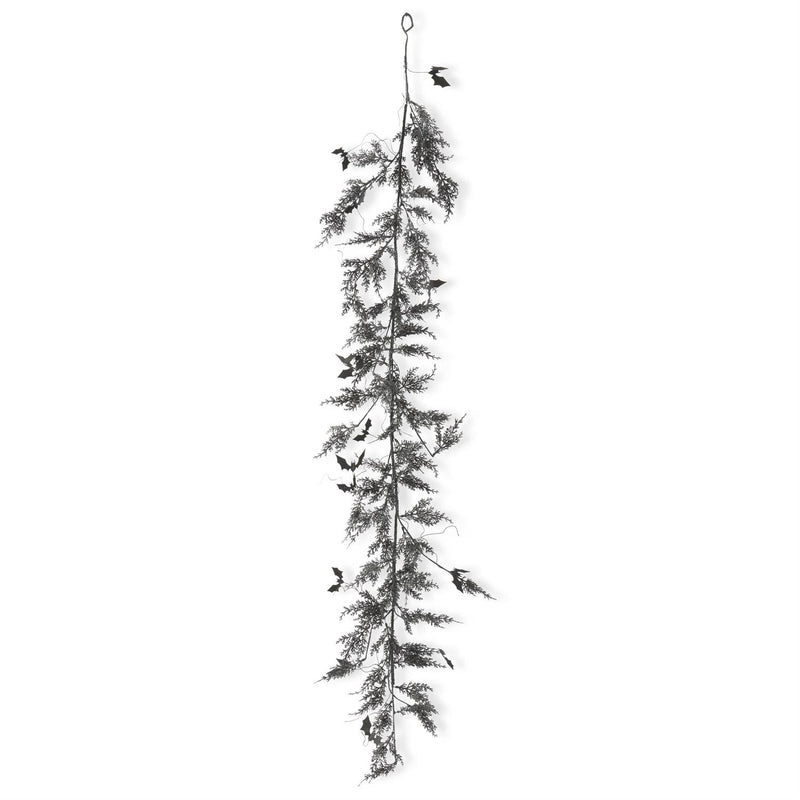 A garland made of pine branches with purple glitter, displayed against a white background.