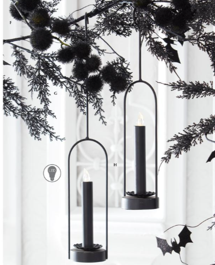 Black candle holders with candles on a white background with decorative elements.