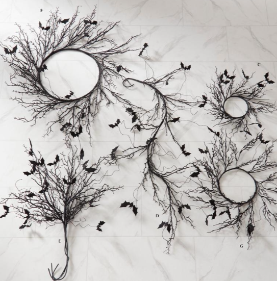 Decorative branches with circular elements and small black birds on a textured white background