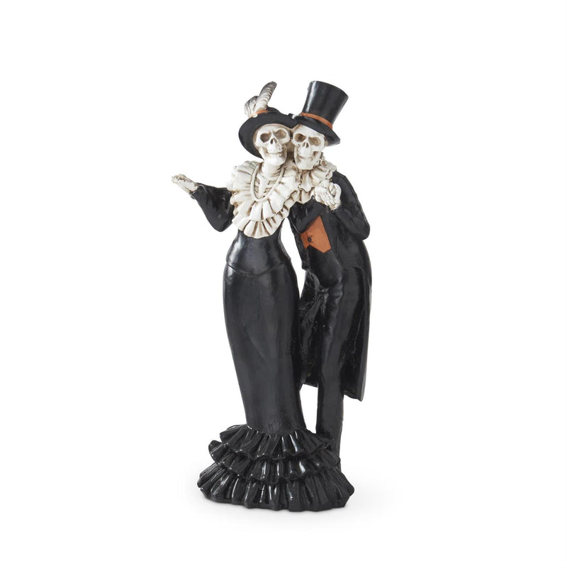 Decorative figurine of two skeletons in formal attire on a white background