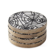 Set of four round coasters with spider web design on a white background