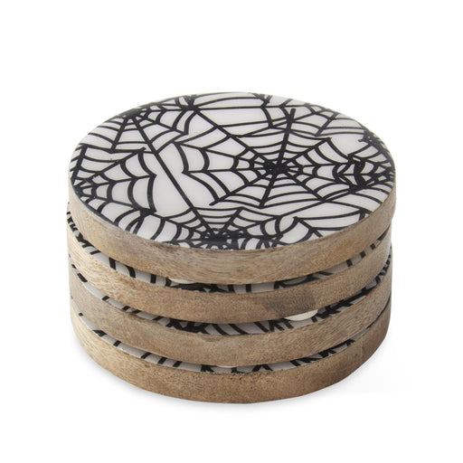 Set of four round coasters with spider web design on a white background