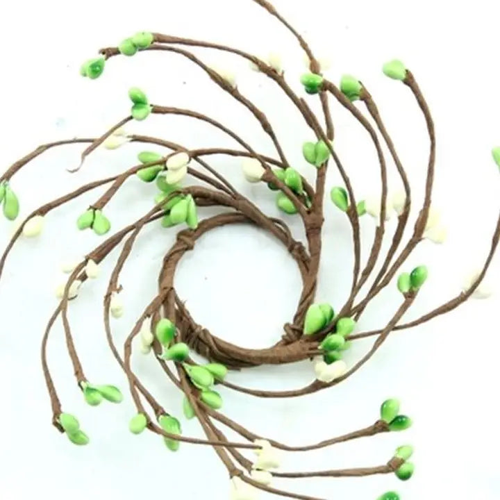 Decorative wreath with green and white berries on a white background