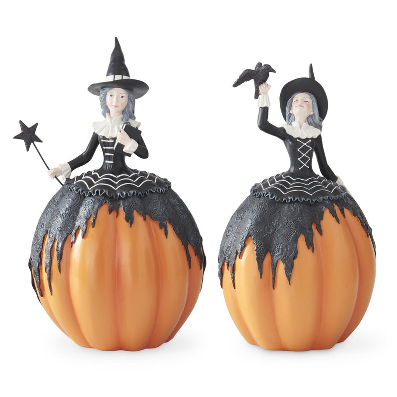 Two Halloween-themed witch figurines on pumpkins with a white background
