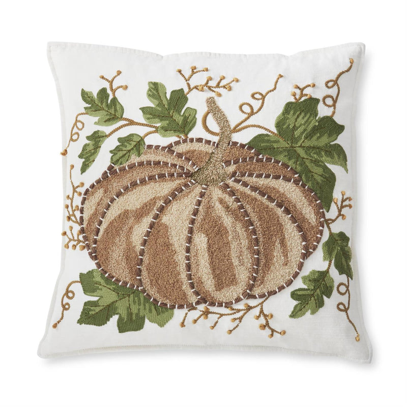 Decorative pillow with embroidered pumpkin and leaves on a white background
