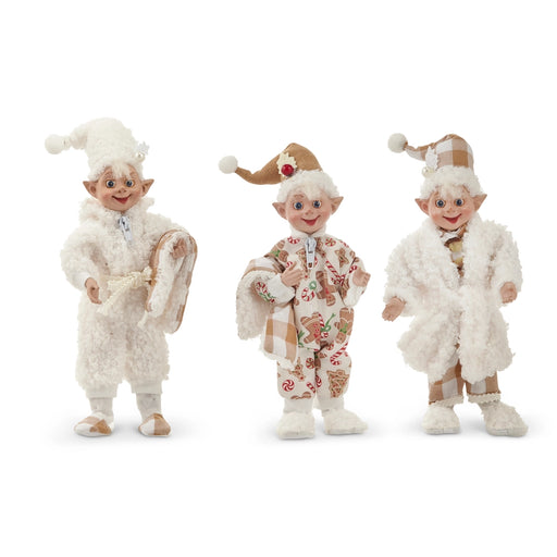 Three elf figurines in festive outfits on a white background