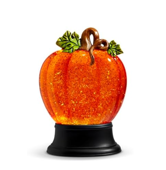 A decorative water pumpkin with swirling glitter, lighted from within, displaying an orange and green color with a glittery texture, mounted on a black base.