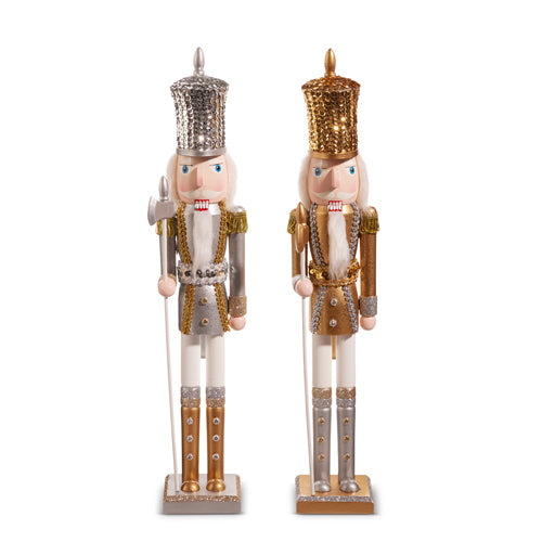 Two decorative nutcrackers with gold and silver outfits on a white background