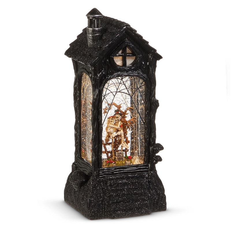 Decorative black lantern with a small scene inside on a white background