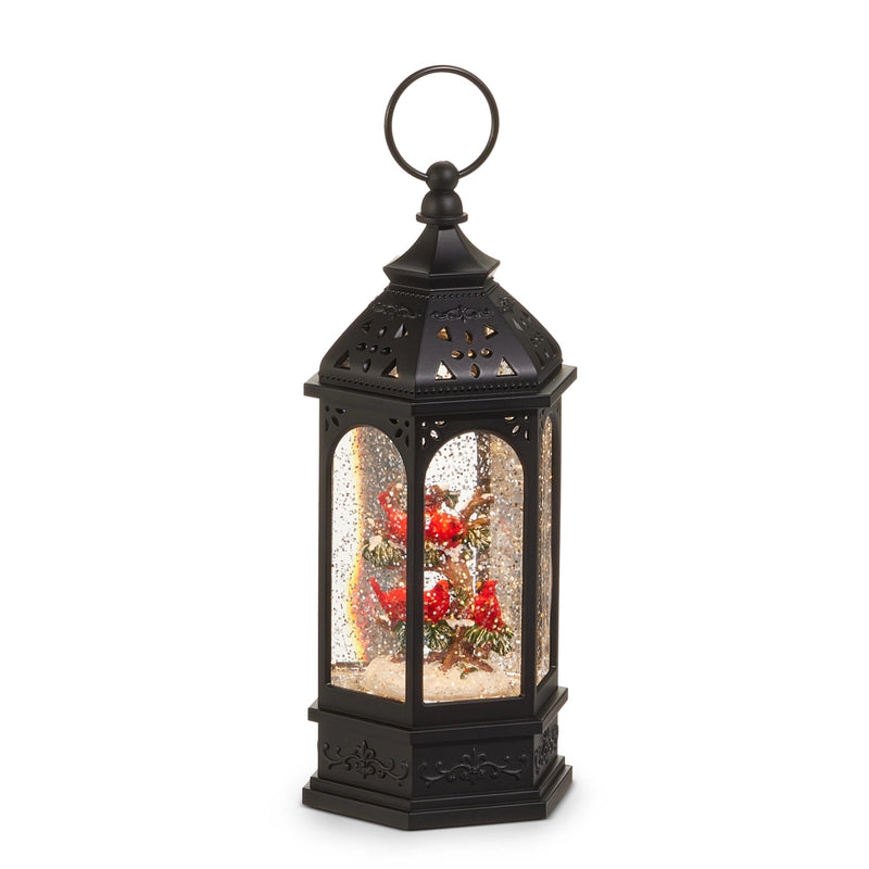 Decorative black lantern with a snow globe inside on a white background