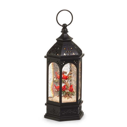 Decorative black lantern with a snow globe inside on a white background