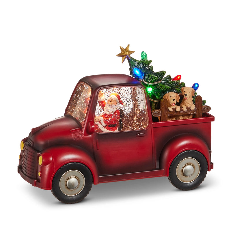 Decorative red truck with a Christmas tree and lights on a white background