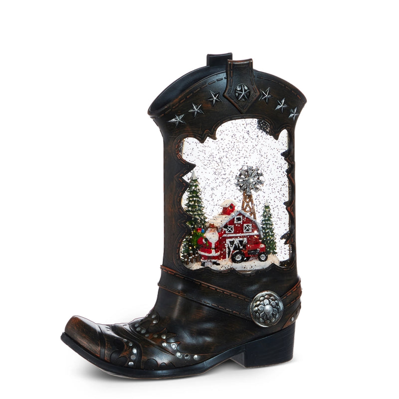 Decorative cowboy boot with a Christmas scene inside on a white background