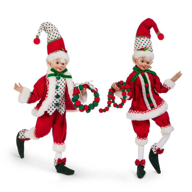 Two Christmas elves in red and white outfits with festive hats holding a garland on a white background.