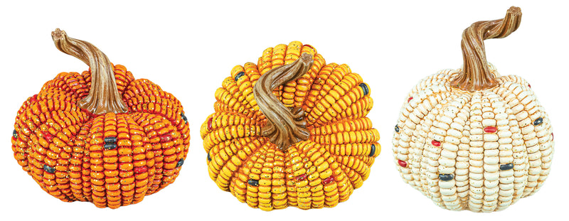 Three decorative pumpkins made from seed beads, shown side by side on a plain white background. The left pumpkin is orange with small multicolor bead accents, the center pumpkin is yellow with small multicolor bead accents, and the right pumpkin is cream/off-white with small multicolor bead accents.