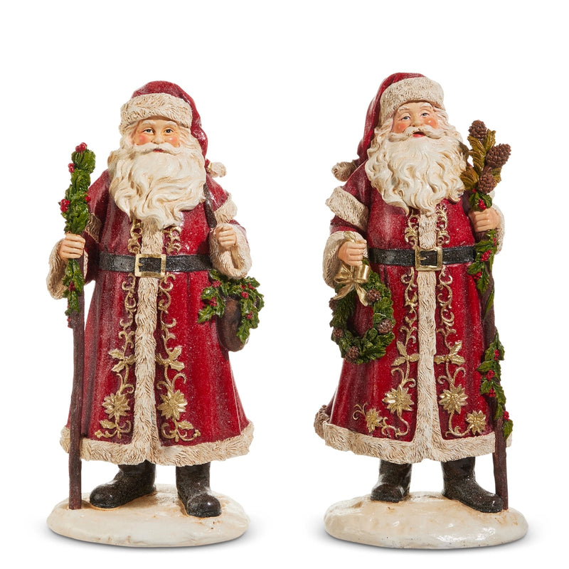 Two decorative Santa Claus figures holding wreaths on a white background