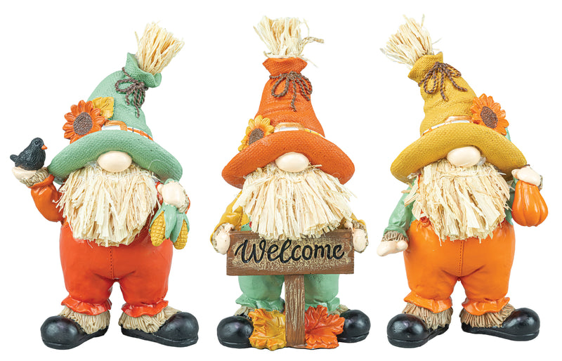 Three autumn-themed gnome figurines standing side by side on a white background. The left gnome wears a green hat and orange pants and holds a black bird.