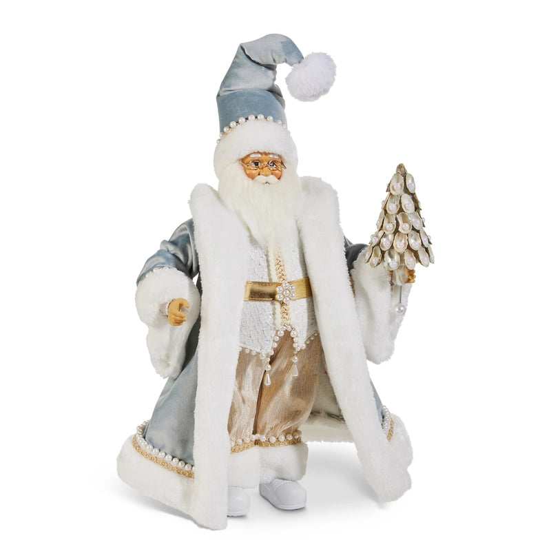 Decorative figure of a Santa Claus-like character in a white and blue outfit with a hat, holding a small tree on a white background.