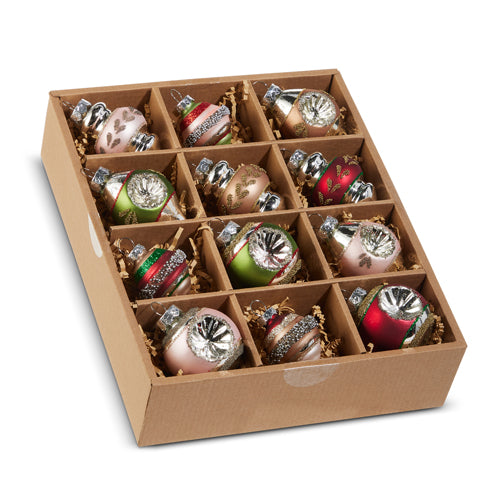 A set of vintage ornaments displayed in a cardboard box with compartments, containing various colored glass balls and decorative elements.
