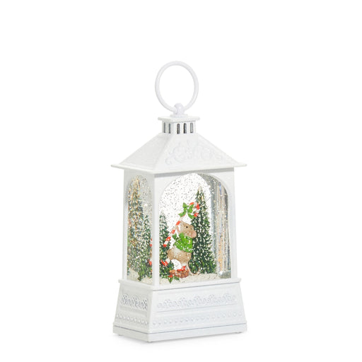 White lantern-shaped snow globe with a deer and trees inside on a white background