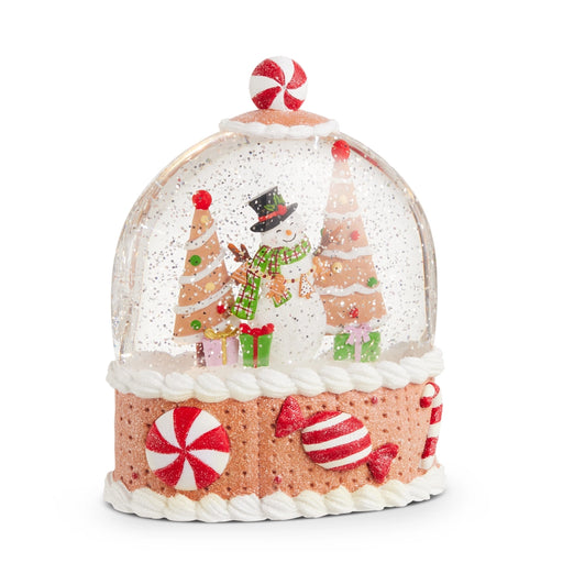 Christmas-themed snow globe with gingerbread house design on a white background