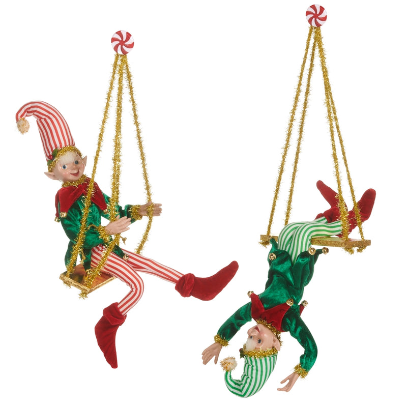 Two Christmas elf figurines on a swing against a white background