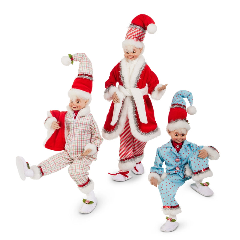 Three Christmas-themed dolls in festive outfits on a white background