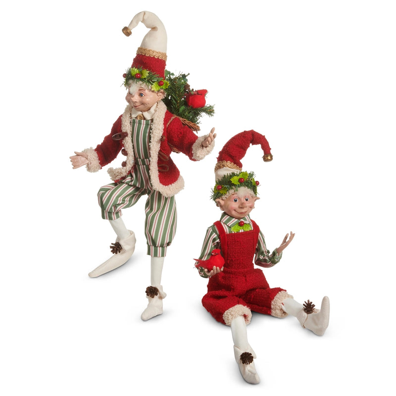 Two Christmas elves in festive outfits with wreaths on a white background