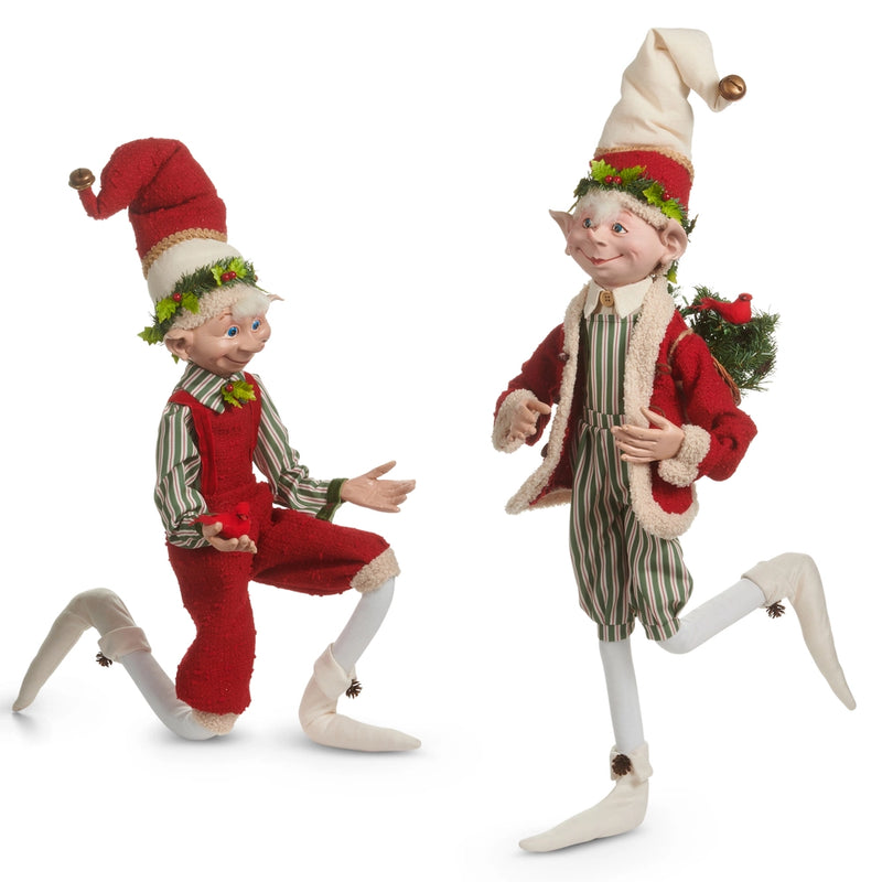 Two Christmas elves in festive outfits on a white background