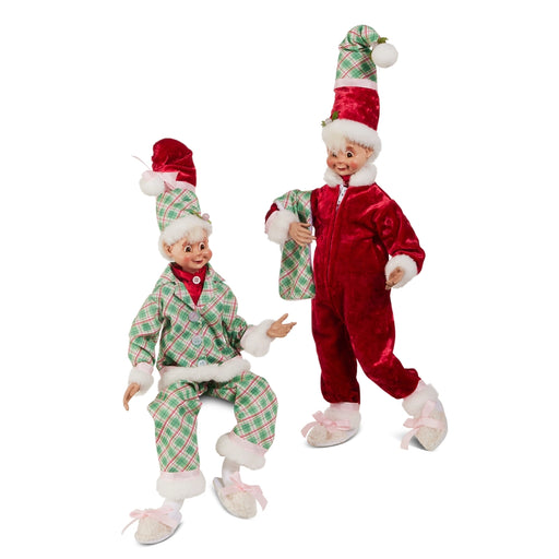 Two Christmas elves in red and green outfits on a white background
