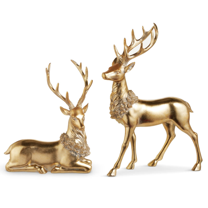 Two gold deer figurines on a white background