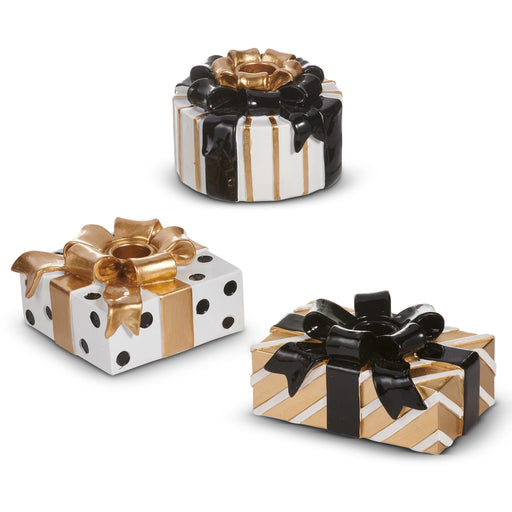 Three decorative gift boxes with bows on a white background