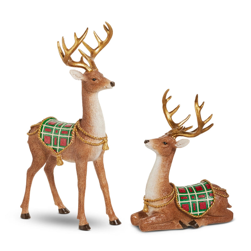 Two decorative deer figurines with plaid blankets and gold accents on a white background