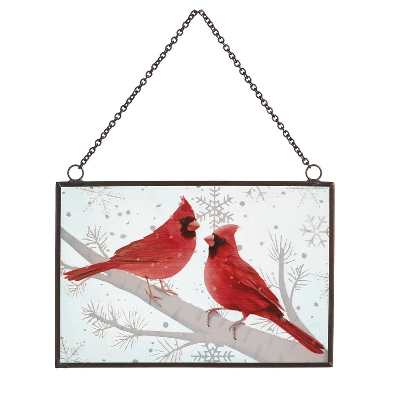 Decorative wall hanging with two red cardinals on a branch against a snowy background.