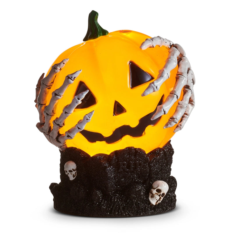 Halloween-themed pumpkin with skeleton hands and skulls on a white background