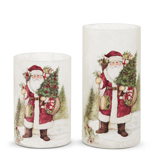 Two Christmas-themed candles with Santa Claus designs on a white background